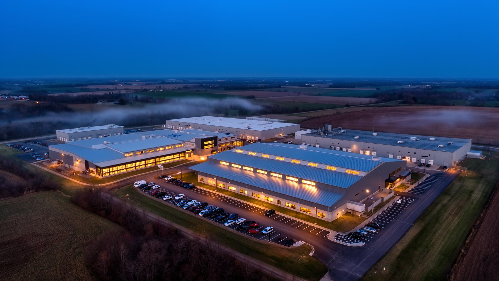 Aerial view of a domestic defense manufacturing campus at dusk